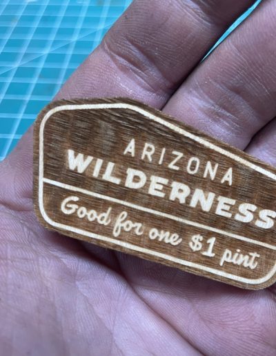 arizona wilderness wood bar token in hand