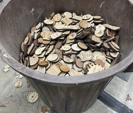 bin full of wood tokens that didn't make the cut