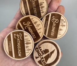 Camp Cho Yeh wood tokens in hand