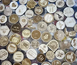 variety of custom engraved wood nickels and tokens