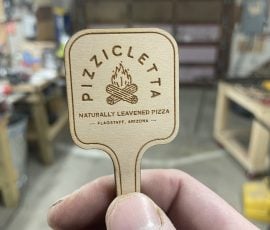 pizza peel custom wood token in hand