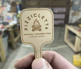 pizza peel custom wood token in hand